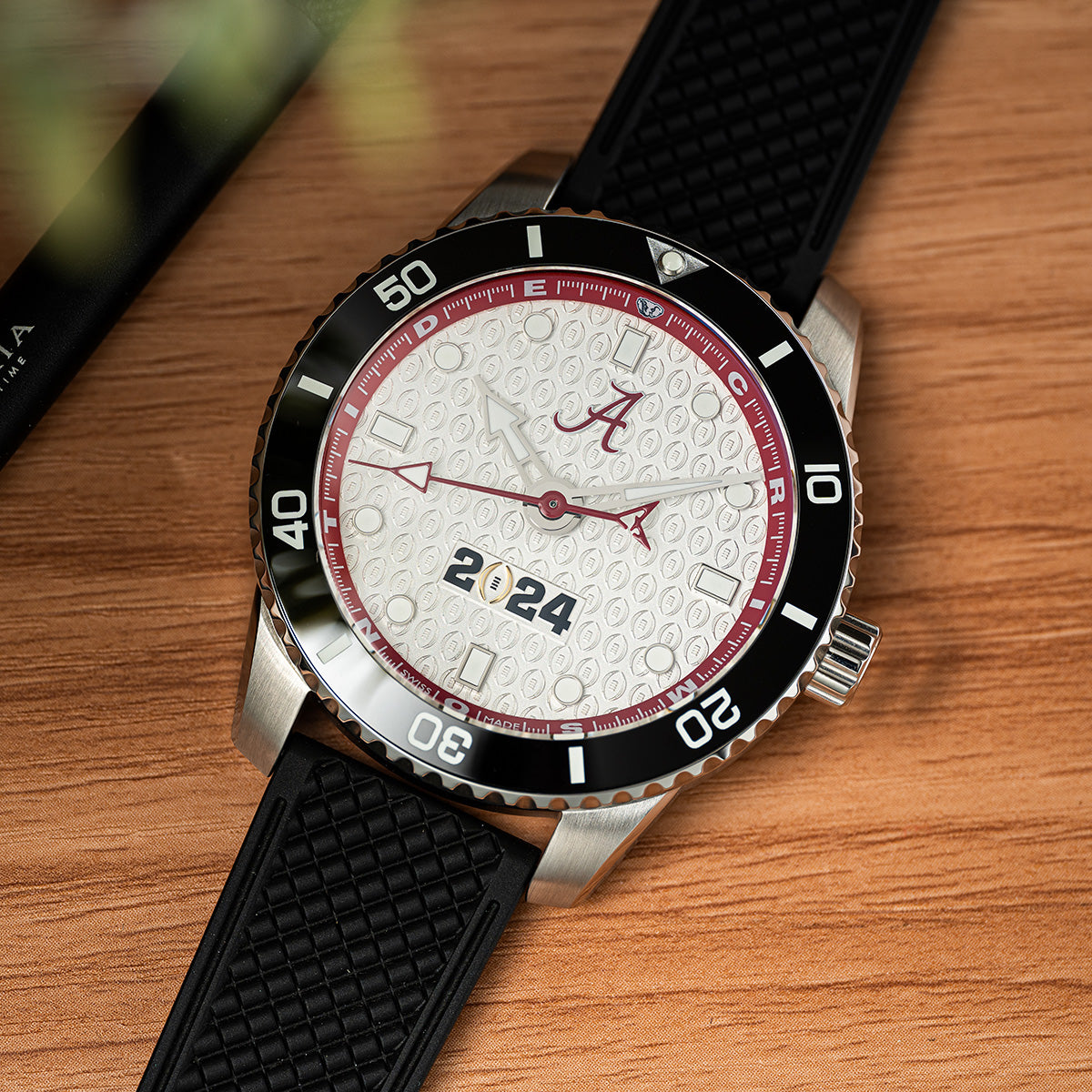 CFP 2024 Alabama Crimson Tide Odysseus swiss made automatic watch. Rubber strap on table.