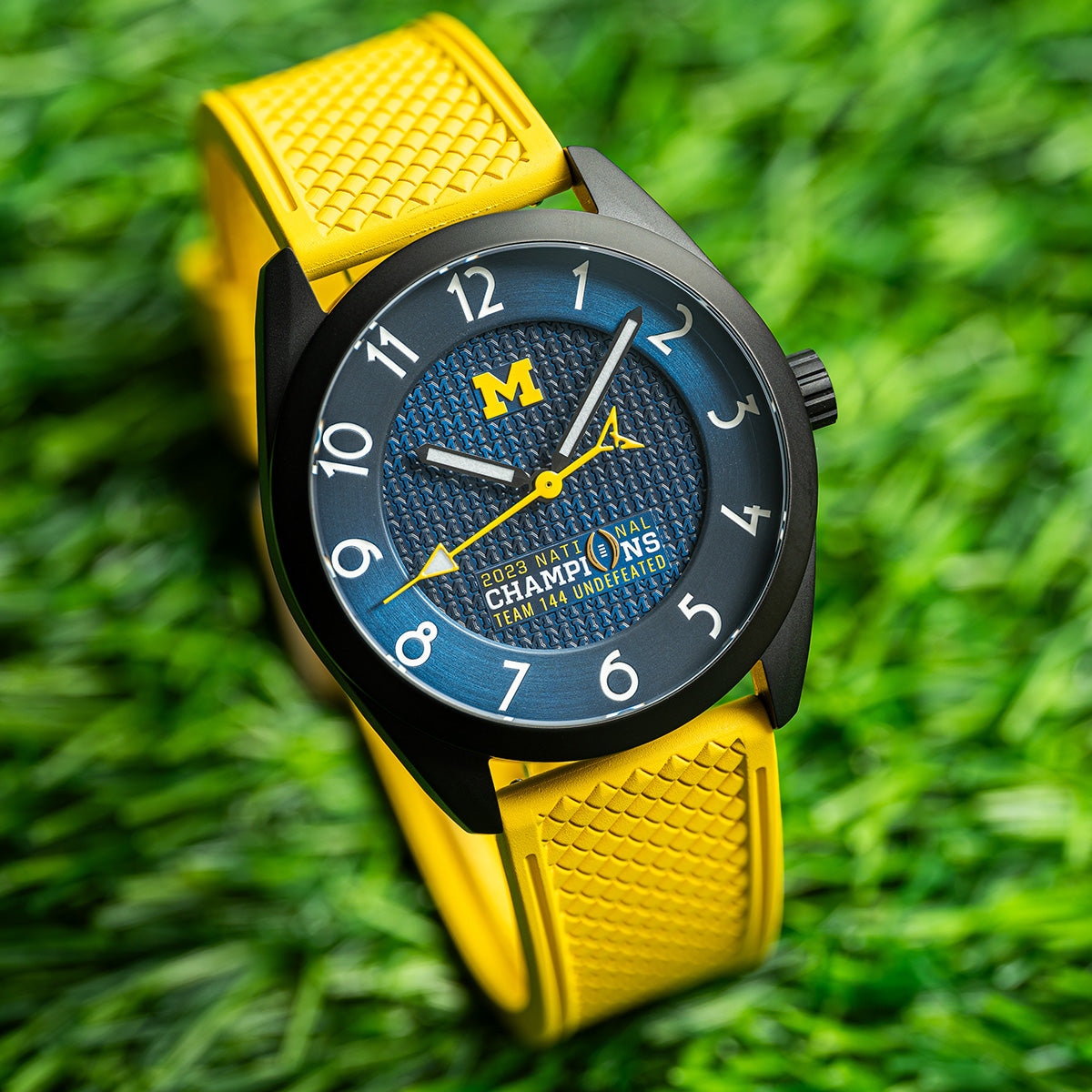 Michigan 2023 National Champions Black PVD Kairos II CFP 2024 swiss made automatic watch. Yellow strap on grass.