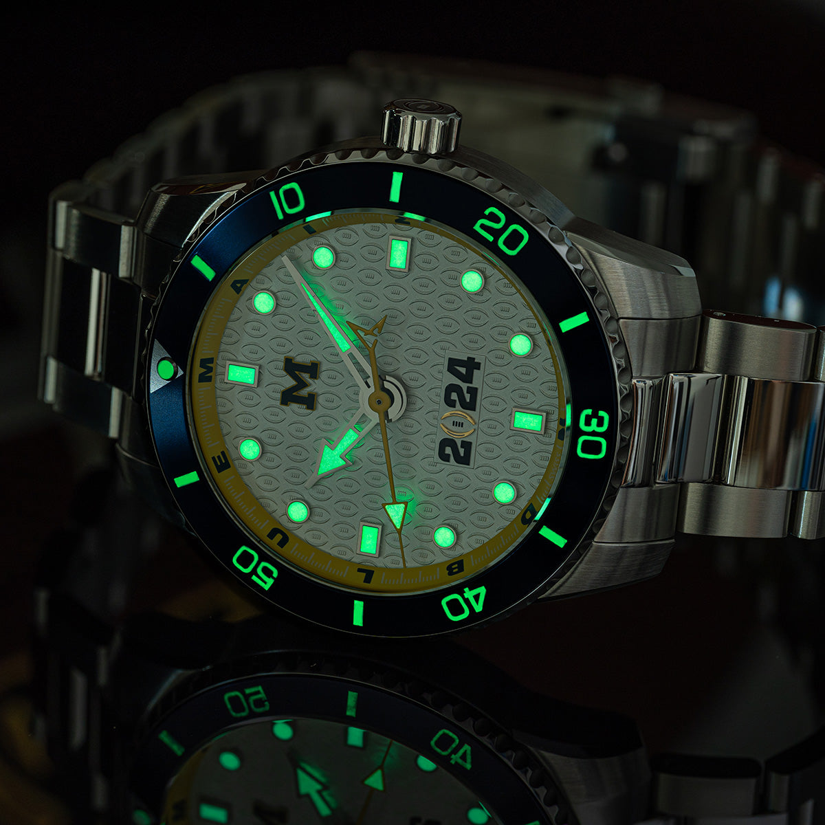 CFP 2024 Michigan Wolverines Odysseus swiss made automatic watch. Lume view (glow in the dark) on a mirror.