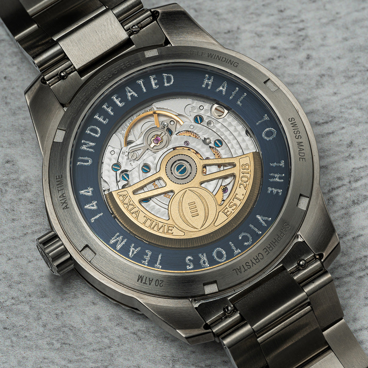 Michigan 2023 National Champions Odysseus CFP 2024 swiss made automatic watch. Stainless steel bracelet. Back view of exhibition case with engraving (back view).