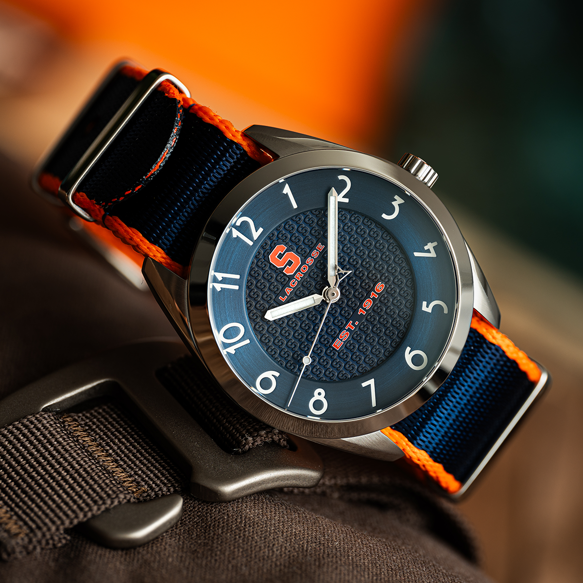 Syracuse lacrosse Swiss made automatic watch. Table view with color-matched NATO strap.