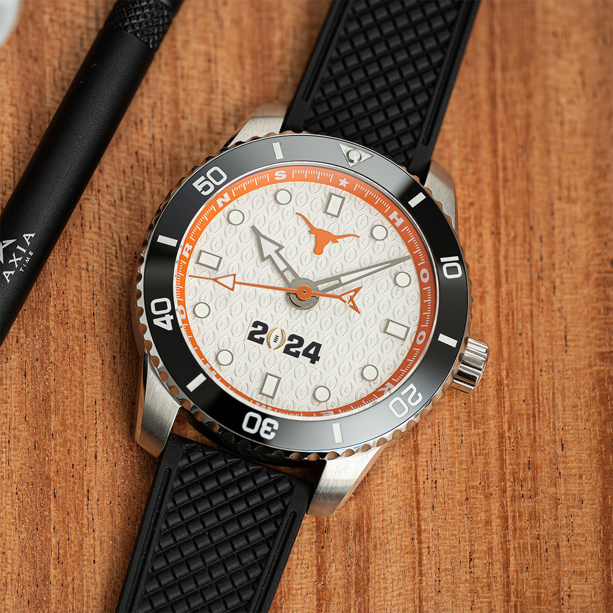 CFP 2024 Texas Longhorns Odysseus swiss made automatic watch. Rubber strap on the table.