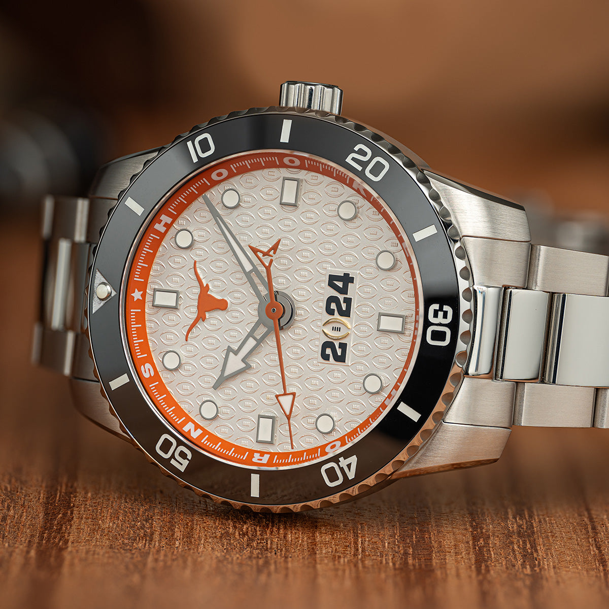 CFP 2024 Texas Longhorns Odysseus swiss made automatic watch. Stainless steel on the table.